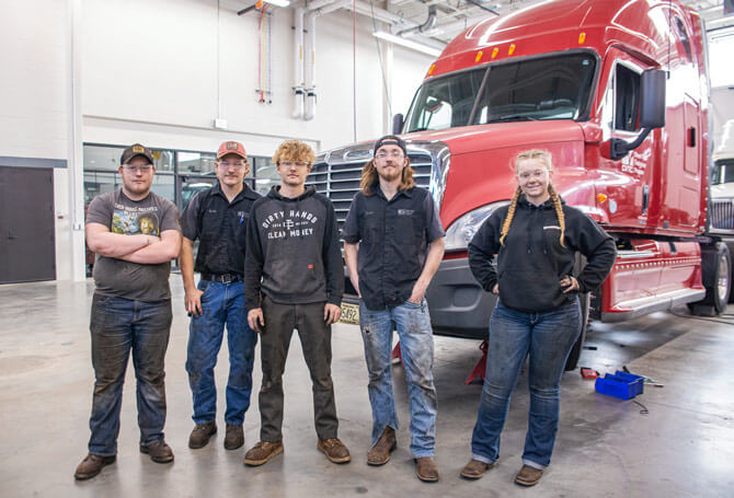 Diesel Technician students standing in front of a semi truck