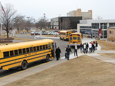students getting out of buses
