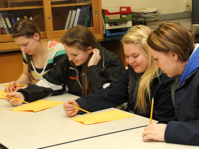 students writing in classroom