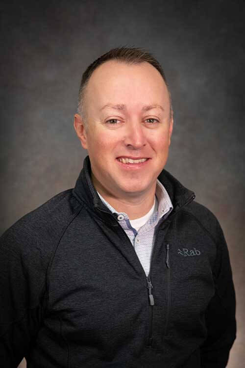 Headshot of Travis Christman, President