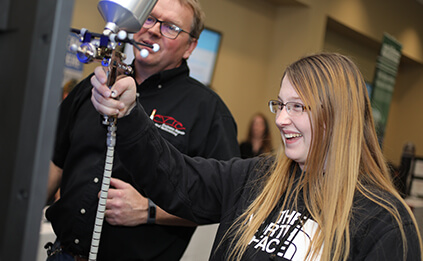 Student attempting virtual spray booth