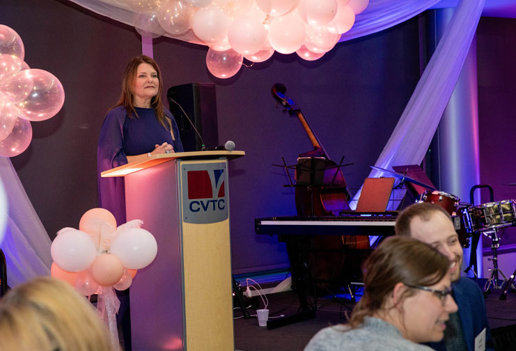Foundation director at a podium during a fundraising event