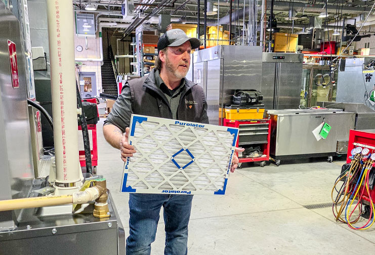 Fred Kosier CVTC HVACR instructor shows a clean furnace filter
