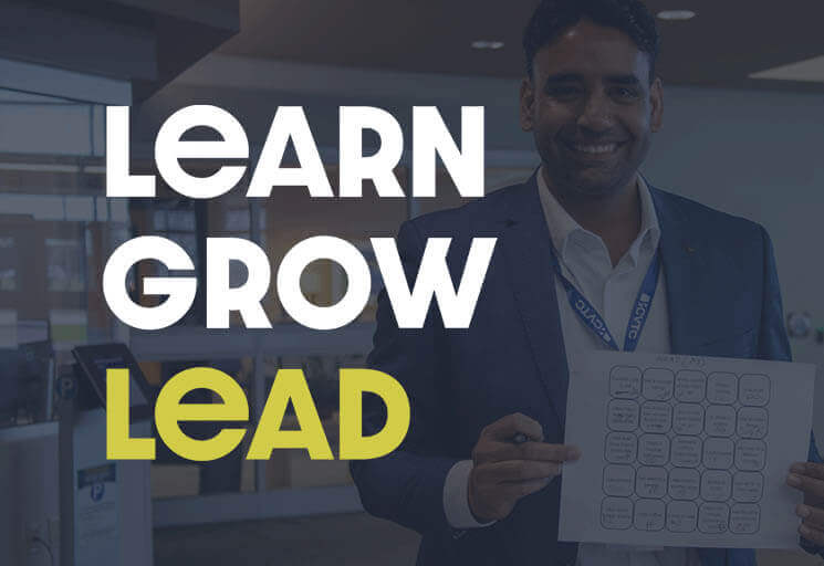 Learn Grow Lead event title with smiling man standing with a certificate.