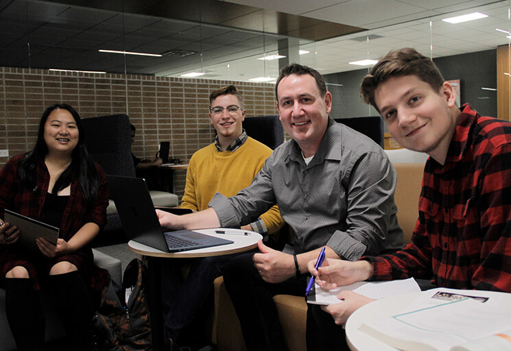 Students Smiling w/ Laptop