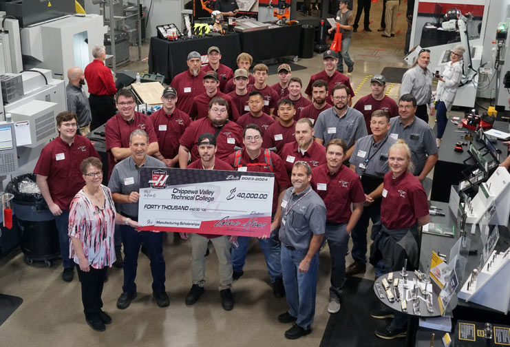 Manufacturing students with big check