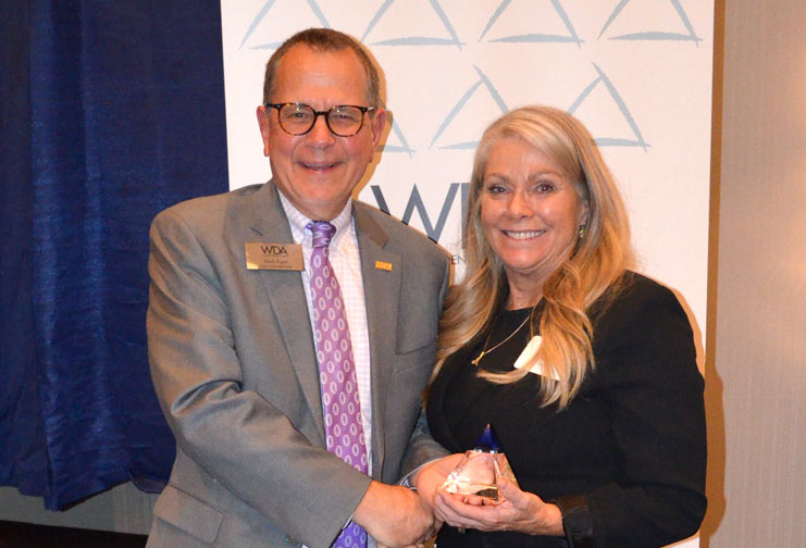 male and female with award at Wisconsin Dental Association 