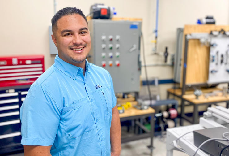 man with blue shirt in electrical room at college