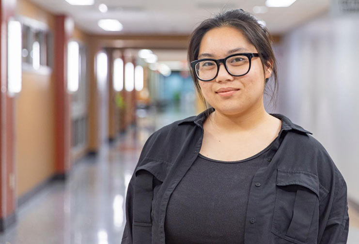 Woman in black with black glasses in college