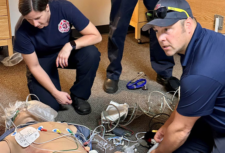 A man and a woman from Eau Claire Fire & Rescue take part in a training simulation.