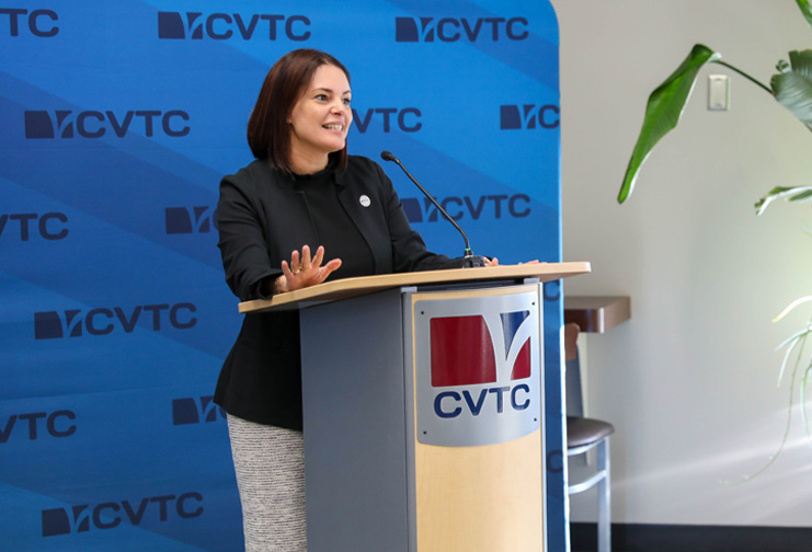 Sunem Beaton-Garcia standing at a CVTC podium at a technical college.