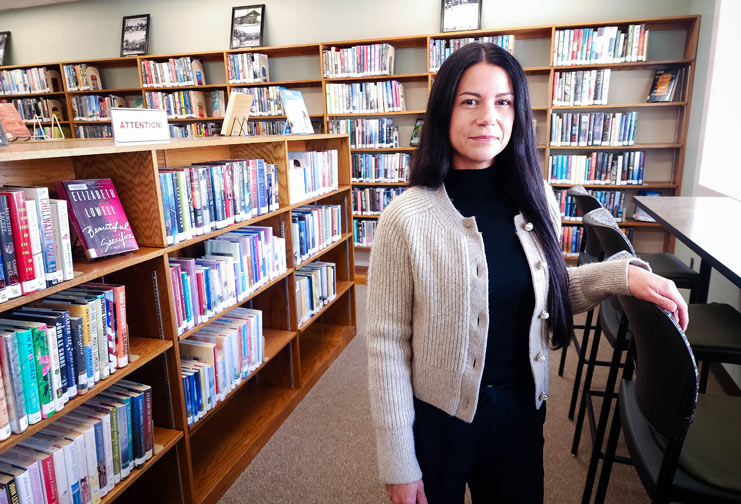 Fall Creek Public Library director standing in the library on Lincoln Avenue.