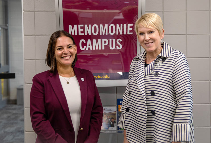 Two college administrators smiling