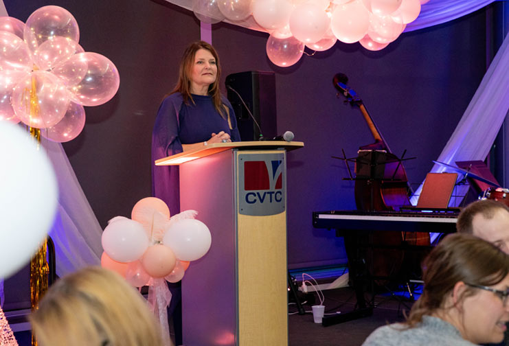 Woman at a podium at Chippewa Valley Technical College during a fundraising event.