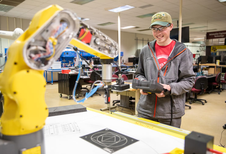 CVTC Automation students at a machine