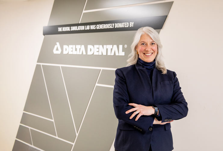 Shannon Semmerling, delta dental of Wisconsin, in front of the dental simulation lab at CVTC