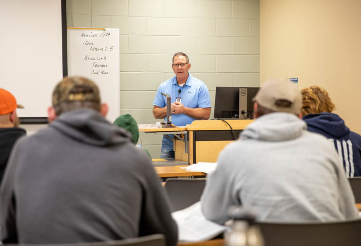 Technical college male instructor in front of apprenticeship students.