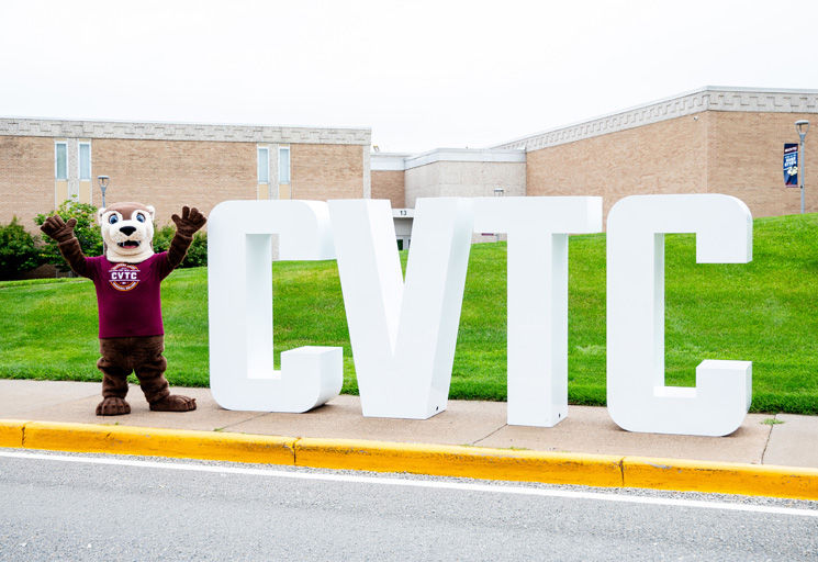 Ollie the river otter at CVTC with the college letters