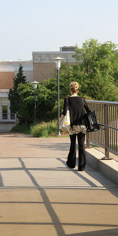 girl walking across bridge